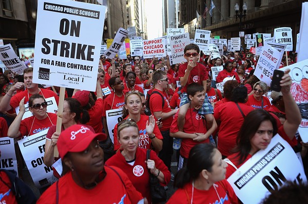 CHICAGO, IL - SEPTEMBER 10:  Thousands of Chicago public school teachers and their supporters march through the Loop and in front of the Chicago Public Schools (CPS) headquarters on September 10, 2012 in Chicago, Illinois. More than 26,000 teachers and support staff hit the picket lines this morning after the Chicago Teachers Union failed to reach an agreement with the city on compensation, benefits and job security. With about 350,000 students, the Chicago school district is the third largest in the United States.  (Photo by Scott Olson/Getty Images)